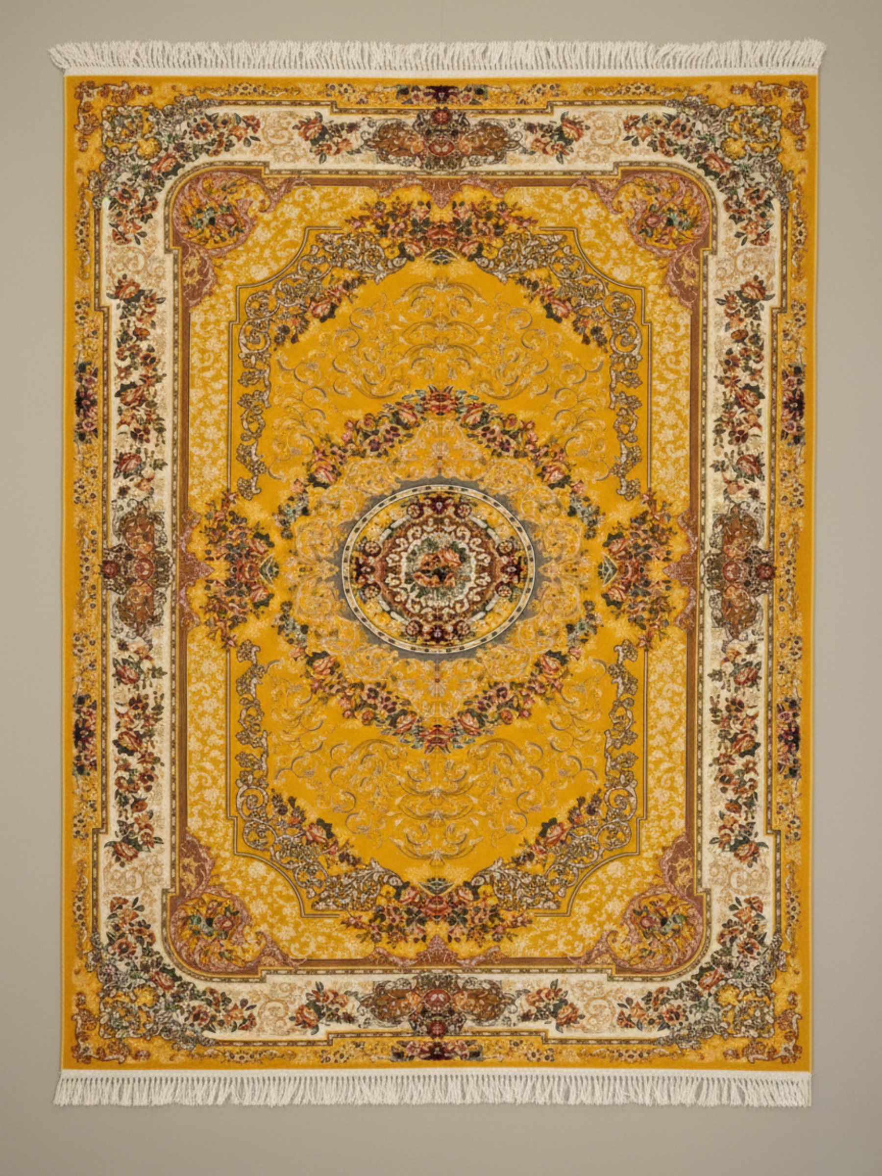 Decorative yellow rug with intricate patterns on a plain background